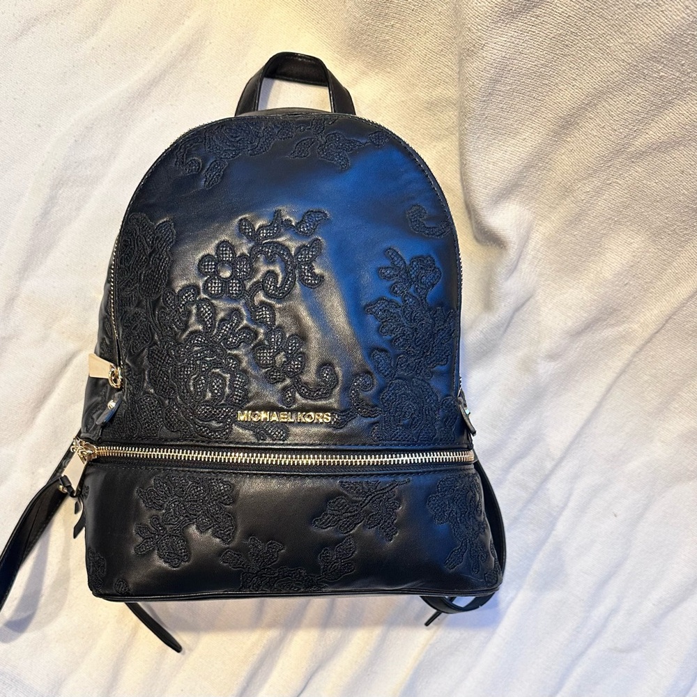 Michael Kors black soft leather embossed backpack.